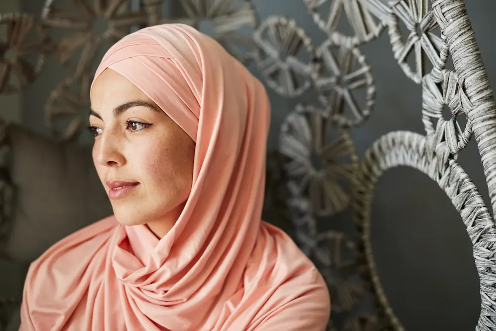 Young woman wearing al amira hijab in soft pink color