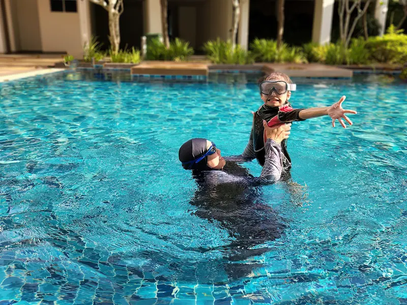 A woman and his daugheter swiming in Burkini hijab suite