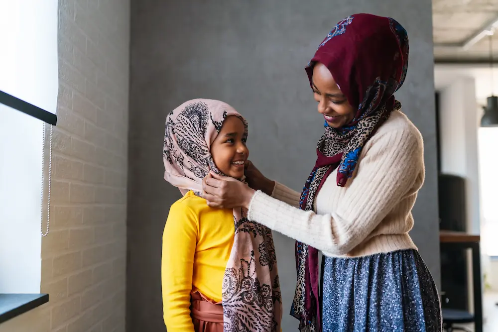 Muslim girl and her mother wearing hijab