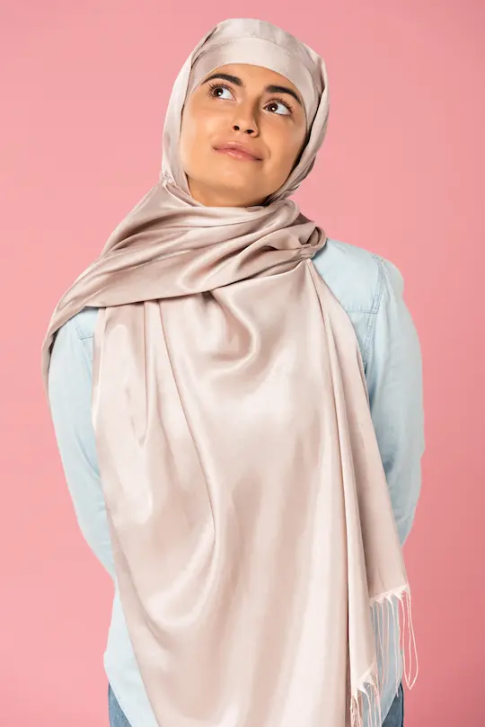 Young woman wearing a pink silk hijab